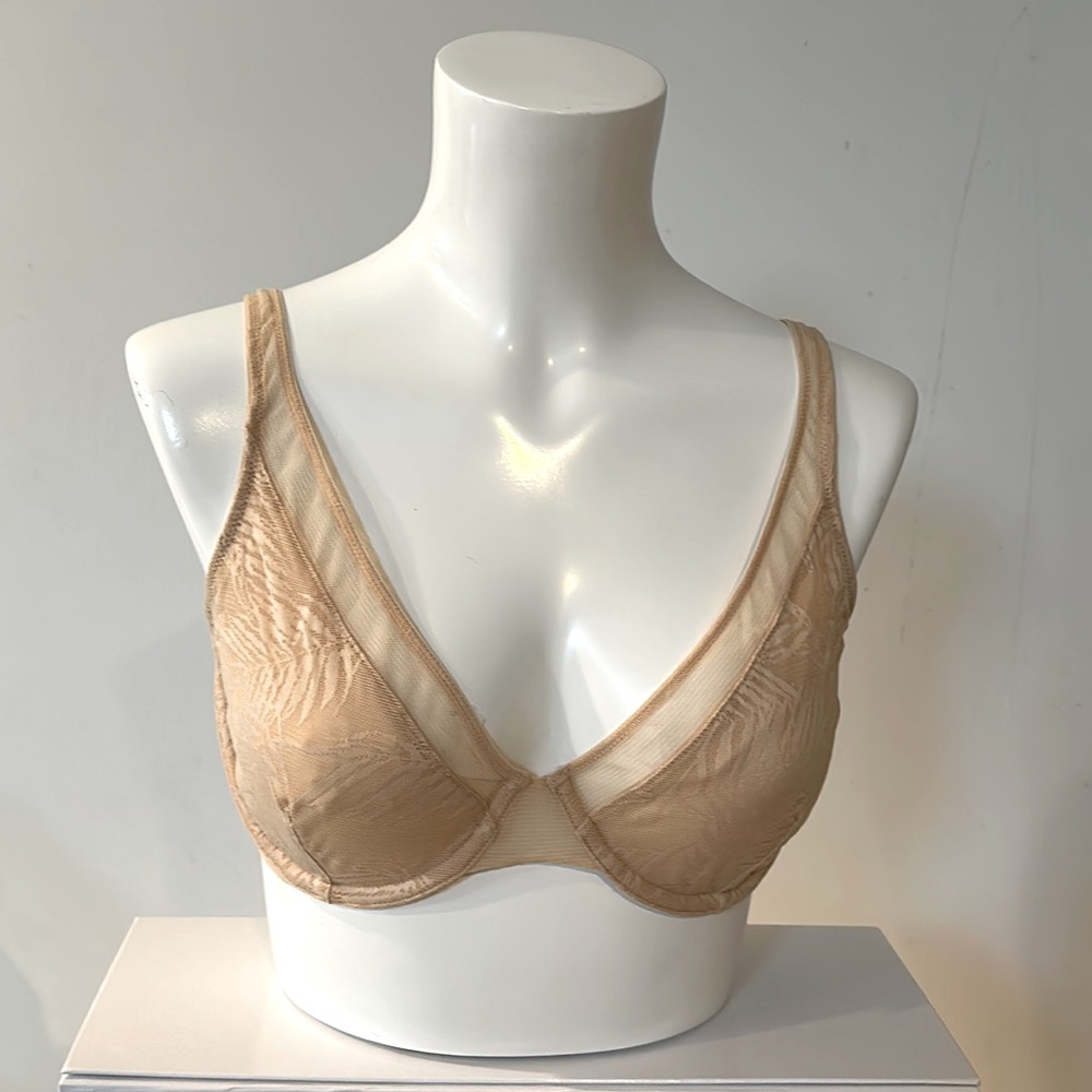 Cream lace unlined bra. Features rear clasp for racerback style.
